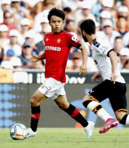 Takefusa Kubo (L), on loan from Real Madrid to Mallorca, dribbles the ball while making his Spanish first-division football league debut during the second half of a match away to Valencia on Sept. 1, 2019. (Kyodo)==Kyodo Photo via Credit: Newscom/Alamy Li