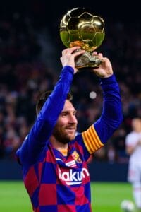 BARCELONA - DEC 7: Messi holds up his sixth Ballon d'Or prior to the the La Liga match between FC Barcelona and RCD Mallorca at the Camp Nou Stadium o