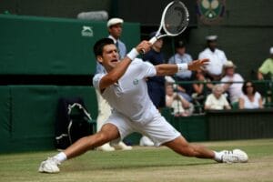 Novak Djokovic reaches wide for a forehand during his his semi-final match against Tomas Berdych at Wimbledon.
