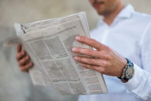 Close-up of businessman reading newspaper