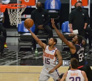 Los Angeles, United States. 08th Apr, 2021. Phoenix Suns' guard Cameron Payne scores on Los Angeles Clippers' forward Patrick Patterwson during the first half at Staples Center in Los Angeles on Thursday, April 8, 2021. The Clippers defeated the Suns 113-
