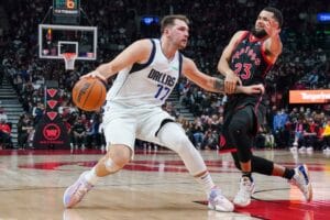 Dallas Mavericks guard Luka Doncic (77) protects the ball from Toronto Raptors guard Fred VanVleet (23) during second half NBA action in Toronto on Saturday, October 23, 2021. THE CANADIAN PRESS/Evan Buhler
