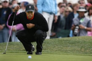 Tiger Woods lines up putt