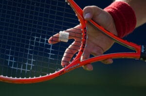 Tennis racket and hand, in preparation to receive serve.