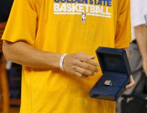 April 10, 2011; Oakland, CA, USA;  Golden State Warriors point guard Stephen Curry (left) is presented with his 2010 FIBA world championship ring before the game against the Sacramento Kings at Oracle Arena.