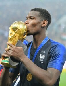 File photo dated July 15, 2018 of France's Paul Pogba kisses the trophy after winning 4-2 the 2018 FIFA World cup final football match France v Croatia at Luzhniki stadium in Moscow, Russia. Manchester United midfielder Paul Pogba on Monday denied media r
